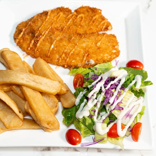 Crispy fried fish with a side of golden french fries and a fresh garden salad.