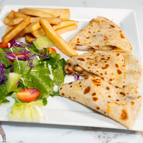 El Cayo's shrimp quesadillas with a side of french fries and a fresh green salad.